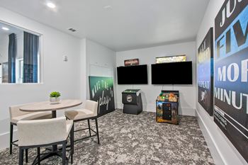 A room with a table, chairs, and a TV.